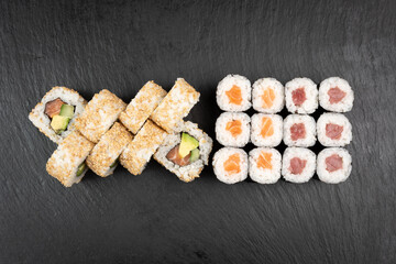 Above ground Japanese sushi food. Maki and rolls with tuna, salmon, shrimp, crab and avocado. Top view of various sushi, all you can eat menu. Rainbow sushi roll, uramaki, hosomaki and nigiri.
