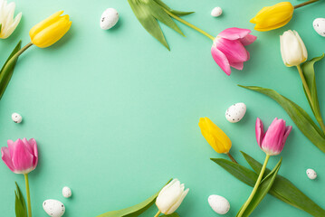 Easter decorations concept. Top view photo of easter quail eggs and colorful tulips on isolated turquoise background with blank space in the middle