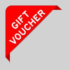 Red color of corner label banner with word gift voucher on gray background