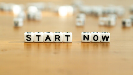 Start now slogan in white block letter beads 