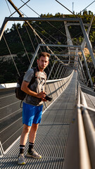young photographer on the road. young photographer on a suspension bridge 