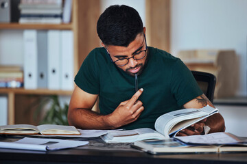 Student, black man and books to study on home desk thinking, reading and studying for college. Person learning and focused on information on page for education, knowledge and working on law research