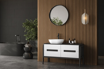 Modern dark bathroom interior with concrete floor, black bathtub and white basin, wooden wall, plant. Minimalist bathroom with modern furniture. 3D rendering