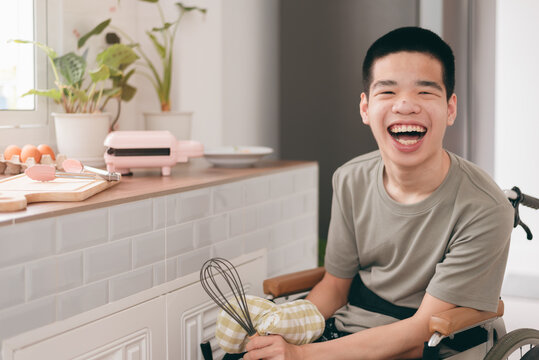 Confidente Teenage Boy With Disability On Wheelchair In Cooking Class Moment In Home Or School,caring For Love And Positive Energy,concept Of Coexistence And Respect For Differences,happy With Myself.