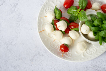 Caprese salad. Skewers with tomato and mozzarella with basil
