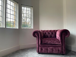 Crushed velvet gothic armchair by the window in a cozy house