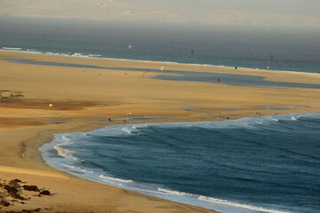 Aerial view of a beach many km long. Tongues of sand brought back by the tides. Contrast between...