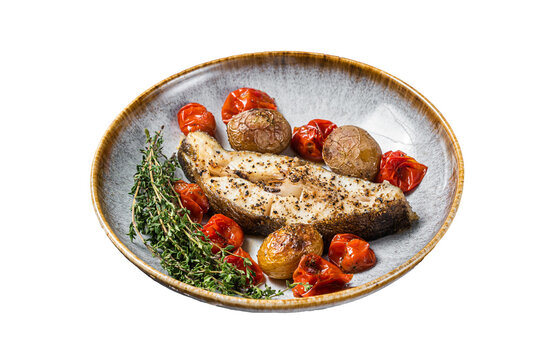 Grilled halibut fish steaks with tomato and potato in plate.  Isolated, transparent background.