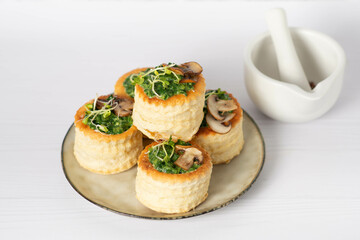 savory puff cups with ham, mushroom and vegetables, selective focus