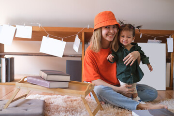 happy and love family, child and motherhood concept happy mother with little baby girl and developmental toys in living room at home.