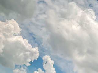 Abstract white fluffy clouds in the blue sky background on sunny day.