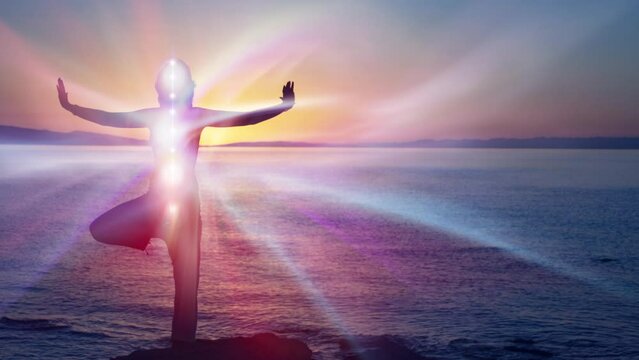 Silhouette of woman in yoga pose on beach sunset view, glowing s