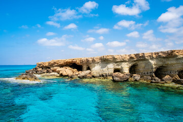 Fototapeta na wymiar Sea caves near Ayia Napa in Cyprus. Natural rock formation famouse for cliff jumping into clear water. Dramatic coastline between Agia Napa and Cavo Greco National park