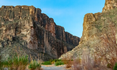 Cliffs rise steeply from Rio Grande River. A view of Santa Elena Canyon in Big Bend National Park.