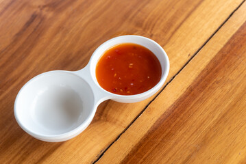 Fototapeta na wymiar dipping sauce condiments in white cup on wooden background photo