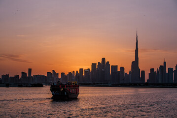 Boat cruise sunset silhouette of Dubai from the Creek 