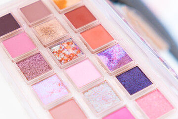 A multicolor palette of trendy pink glitter eye shadows.