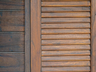 Wooden window with brown shutters background. Close-up pattern texture of traditional asian style wood work, window and wall backgrounds.