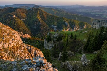 Hiking in mountains Velka Fatra in Slovakia. Beautiful view from Tlsta. Wild valley with rocks and spruces. Spring sunset in the mountain landscape, discover the beauty of spring hiking