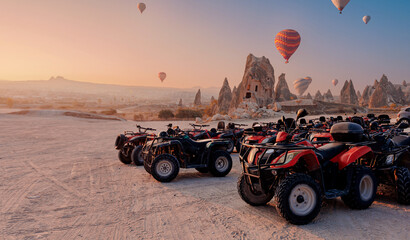 ATV quadbike in Cappadocia background set colorful hot air balloon fly in sky with sunset © Parilov
