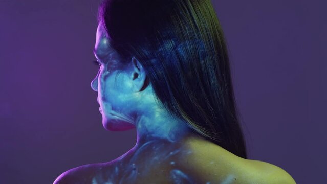 Female galaxy. Double exposure portrait. Inner world. Back view of tranquil woman posing colorful neon light background space shimmering misty flow overlay.