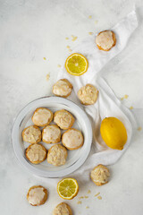 Homemade Italian lemon shortbread cookies with glaze and almond. Shortbread citrus biscuits on white stone background