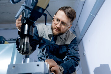 Worker man engineer professional control drilling CNC on industry factory