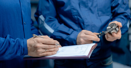 Team work caucasian engineer professional man worker set up and control CNC machinery on industry factory