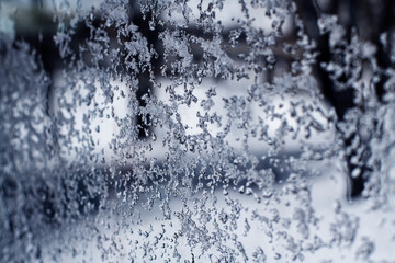 Frozen ice drops patterns on window glass