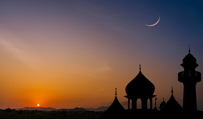 Silhouette mosques on sunset sky twilight with crescent moon over mountain landscape, religion of...