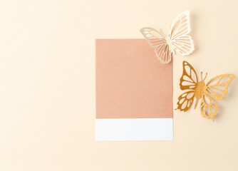The Blank reminder note and carve of paper butterfly on yellow background, space for text.
