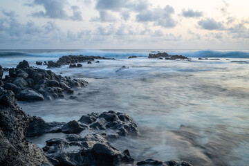 Oceanscape during the sunset with waves and rock, Ascension island.