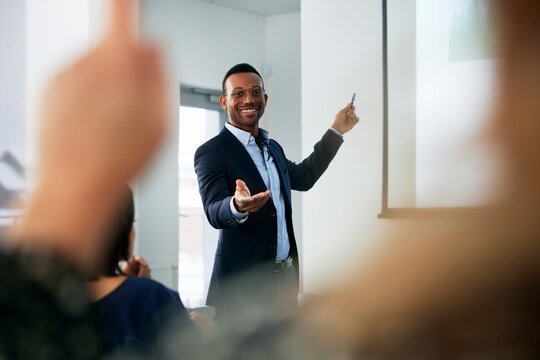 Businessman presenting before colleagues during meeting