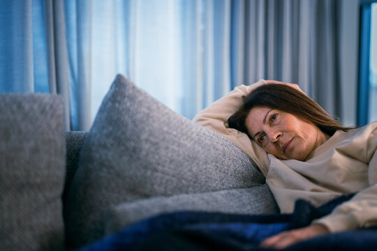 Ill woman lying on sofa