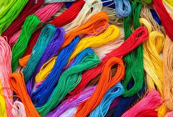 Threads for embroidery are multi-colored. Selective focus.