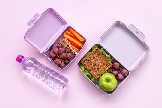 Healthy snacks and vegetables in lunch boxes. Top view