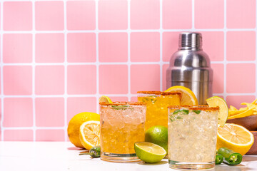 Set of tequila margarita mexican cocktails, with jalapeno pepper, lime and spicy rim, on...