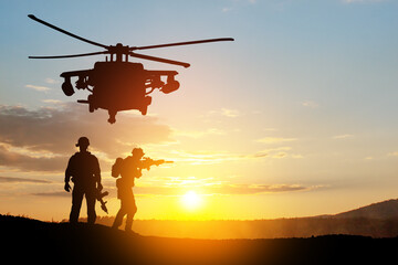 Silhouettes of helicopter and soldiers on background of sunset. Greeting card for Veterans Day,...