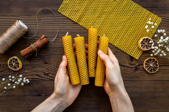 DIY - do it yourself concept. Hands making beeswax honey aroma candles