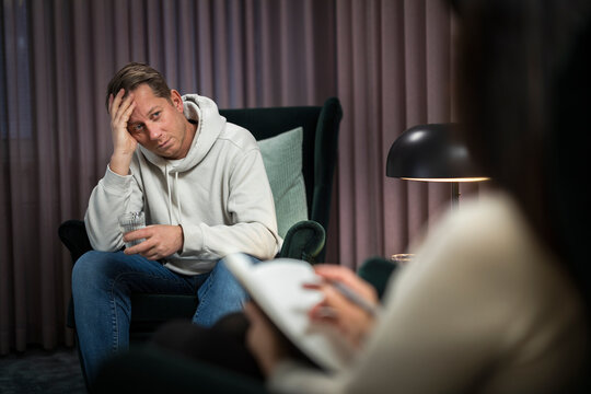 Man sitting in armchair at therapy session