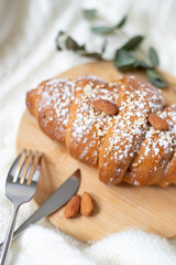 Fragrant fresh croissant on a wooden plate