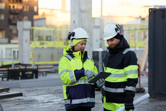 Construction engineers working at construction site