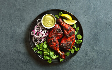 Tandoori chicken served with cilantro and onion