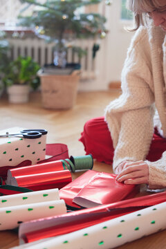 Woman's hands packing Christmas presents