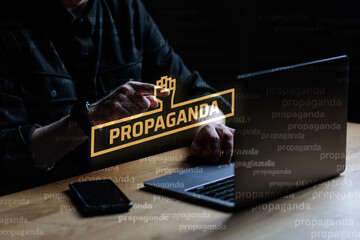 Propaganda visual concept. Man points finger at Propaganda text