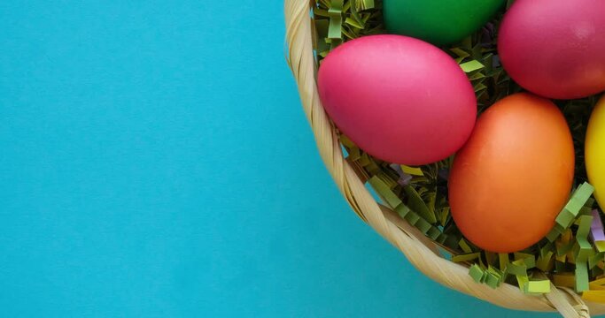 The brush paints a white egg red and it goes into a basket of colored Easter eggs. 4K stop motion animation