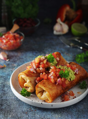 A typical dish of Mexican cuisine - Chimichanga, made of tortilla with different ingredients