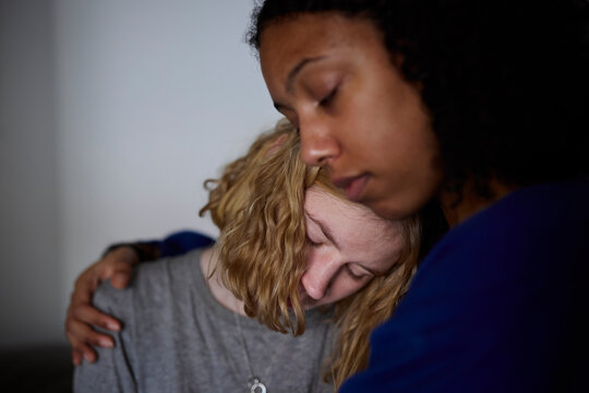 Young woman comforting crying friend