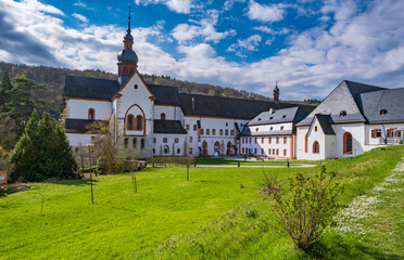 View of the basilica of the Eberbach monastery near Kiedrich/Germany in the Rheingau on a sunny spring day - obrazy, fototapety, plakaty
