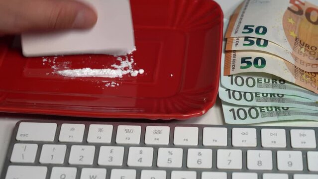 Drug cocaine substance abuse and addiction hard illegal drugs - use illegal drugs in the workplace at the computer in the office - worker uses cocaine to last longer and resist the daily tiredness